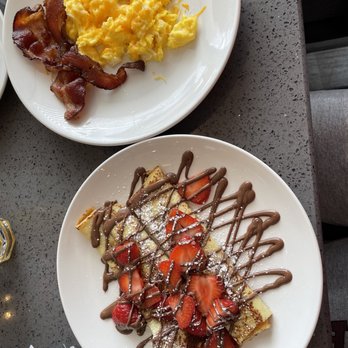 Eggsquisite Cafe - Allen - Crepe combo: Nutella & Strawberries w/two eggs, bacon and sausage patties. - Breakfast & Brunch Near Me - Allen, Texas