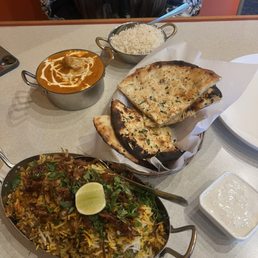 Chicke biryani, garlic cheese naan and lamb masala butter chicken breast Chicke biryani, garlic cheese naan and lamb masala butter chicken breast