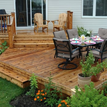 Fence-All - a patio with a table and chairs - General Contractors Near Me - Ottawa, Ontario Fence-All - a patio with a table and chairs - General Contractors Near Me - Ottawa, Ontario