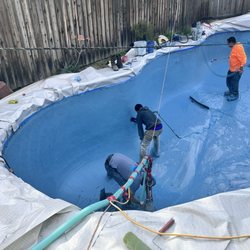 Black Stone Pool Plastering - Crew forming the pool aqua blue mini pebble with crushed abalone shell.