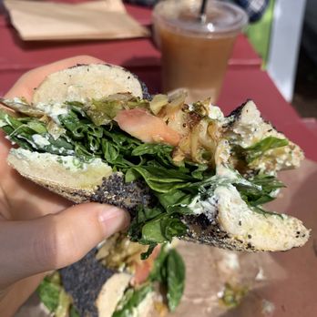 Willow's - Poppy bagels with plain vegan cream cheese, spinach, tomato, and grilled brussel sprouts & an iced coffee with oat milk - Bagels Near Me - Burlington, Vermont