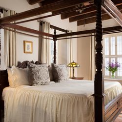Bayfront Marin House - Luxurious bed with ornate wooden bedposts in the Jose Simeon room