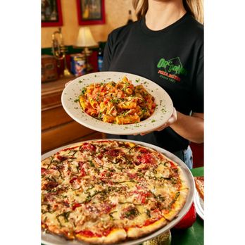 Oregano's - a woman holding a plate of pizza - Pizza Near Me - Mesa, Arizona Oregano's - a woman holding a plate of pizza - Pizza Near Me - Mesa, Arizona