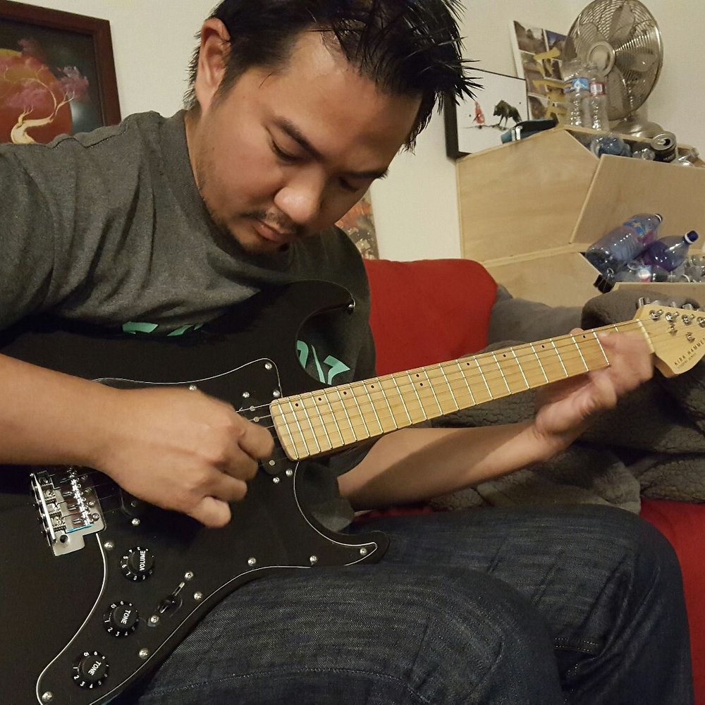 My boyfriend trying out the guitar I bought him. My boyfriend trying out the guitar I bought him.