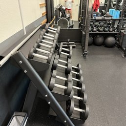 Dumbbell rack, kettlebells, and cable machine. Dumbbell rack, kettlebells, and cable machine.