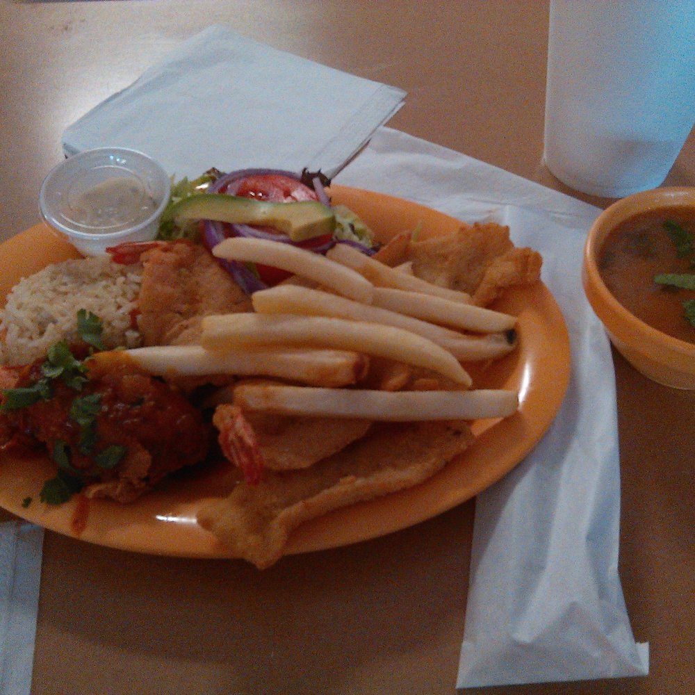 Its a seafood plate Fish and shrimp with a seafood soup on the side Its a seafood plate Fish and shrimp with a seafood soup on the side
