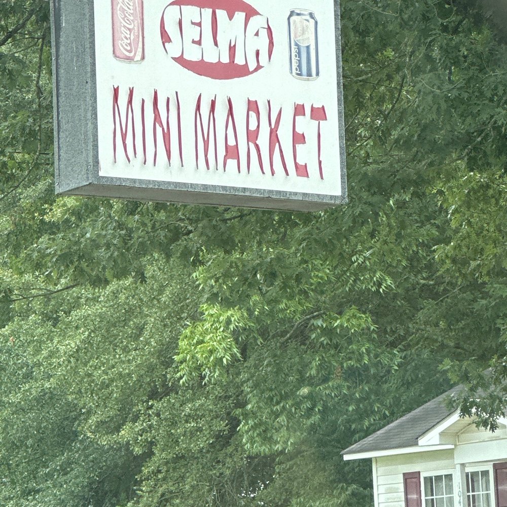 a sign for a mini market a sign for a mini market