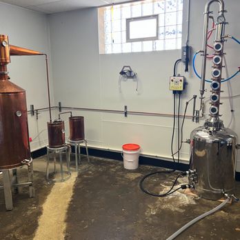 Four Dogs Distilling - a room with a lot of equipment - Distilleries Near Me - Akron, Ohio
