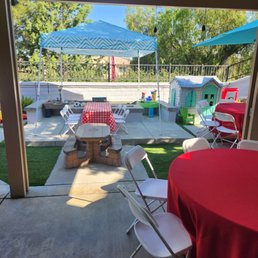 Two round tables, and a kids table with red cloths and chairs. Two round tables, and a kids table with red cloths and chairs.