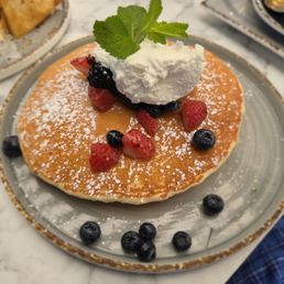 Pancakes with whipped cream and berries