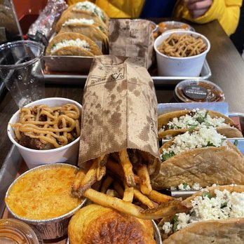 Smoque BBQ - Pecan pudding, mac and cheese, cornbread, fries, and brisket tacos. - Barbeque Near Me - Chicago, Illinois