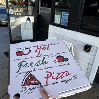 New York Pizza - a hand holding a box of fresh pizza - Pizza Near Me - San Lorenzo, California