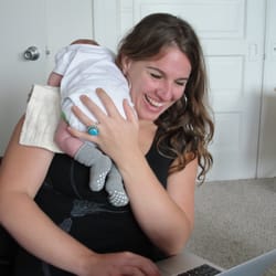 Kristen Cates, CNM - She multitasks too! Kristen holding our baby while typing up notes about our postpartum meeting.