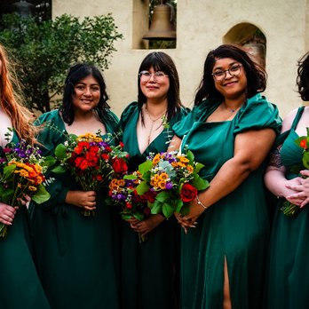 Lantern Florist - A group of ladies in green holding out a stunning array of bouquets! - Florists Near Me