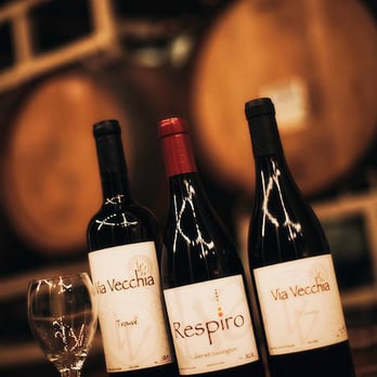 Via Vecchia Winery - three bottles of wine and a glass - Wineries Near Me - Columbus, Ohio