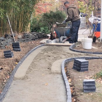Solid Concrete Construction - Laying pavers. - Masonry/Concrete Near Me