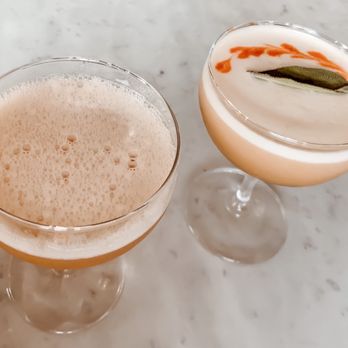Vern's - Left: Lion's Tail - Bourbon, allspice, lime, bitters Right: Autumn Froth- rum, rye, pumpkin, ginger, lemon, whites, bitters - New American Near Me - Rochester, New York Vern's - Left: Lion's Tail - Bourbon, allspice, lime, bitters Right: Autumn Froth- rum, rye, pumpkin, ginger, lemon, whites, bitters - New American Near Me - Rochester, New York