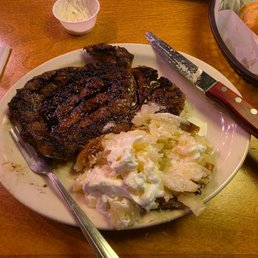 Medium Rare Steak with a bake potato with sour cream and butter. And a Ceasars salad. Medium Rare Steak with a bake potato with sour cream and butter. And a Ceasars salad.