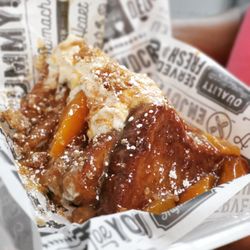 Get Toasted - Peach Cobbler French Toast. (Warm buttery peach cobbler filling, caramelized walnuts, whipped cream, and cinnamon)
