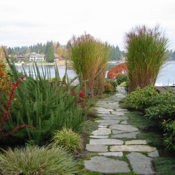Essential Gardeners - a stone path leading to a lake - Landscaping Near Me Essential Gardeners - a stone path leading to a lake - Landscaping Near Me