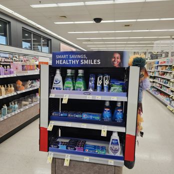 Walgreens - The image shows a pharmacy aisle with a display stand containing oral hygiene products like toothpaste, mouthwash, and toothbrushes. The display has a sign reading 'Smart Savings, Healthy Smiles' and is situated near shelves stocked with various health and beauty items. The store has a tiled ceiling with fluorescent lighting, and the background includes additional shelves with personal care products. - Cosmetics & Beauty Supply Near Me - Cedar Park, Texas