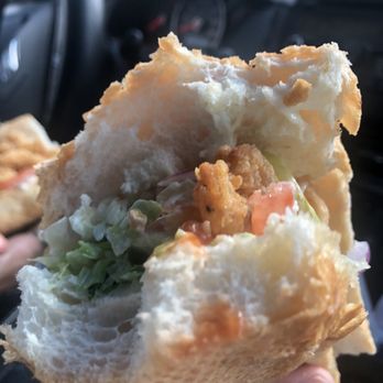 Seafood Express - a person holding a sandwich in their hand - Seafood Near Me - Meridian, Mississippi Seafood Express - a person holding a sandwich in their hand - Seafood Near Me - Meridian, Mississippi
