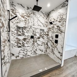 Custom master shower. Double niche, linear drain, large format tile everywhere