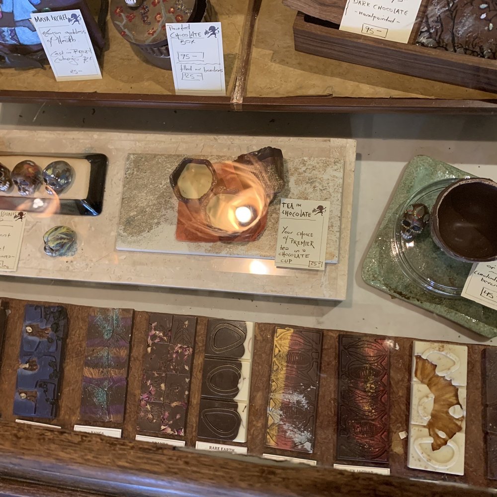 Dancing Lion Chocolate - Various chocolate bars and specialty items for Día de Muertos behind the counter. - Coffee & Tea Near Me - Manchester, New Hampshire