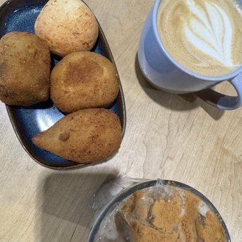 Tupi Coffee - Assorted Brazilian baked goods (from top to bottom): Cheese bread, ground beef rissole, ham and cheese rissole, and coxinha. - Coffee & Tea Near Me - Sacramento, California
