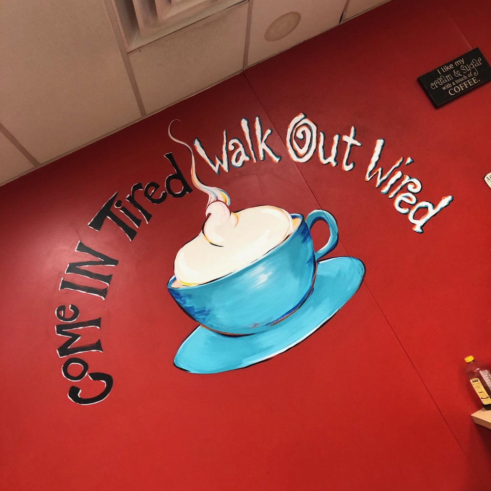 a sign for a coffee shop a sign for a coffee shop