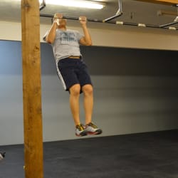 Gate showing us a completed kipping pull-up during a workout.