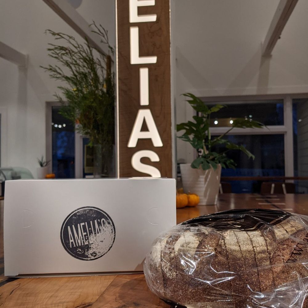 Amelia's - Their country loaf with a box of pastries. - Bakeries Near Me - Indianapolis, Indiana