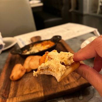 Blackwall Hitch - a hand holding a piece of bread - Cocktail Bars Near Me - Annapolis, Maryland Blackwall Hitch - a hand holding a piece of bread - Cocktail Bars Near Me - Annapolis, Maryland