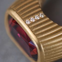 Our Aura ring has two rows of round brilliant Canadian diamonds set in matte 18k yellow gold.