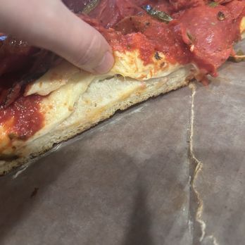 Pequod's Pizza - Undercooked pizza dough. - Pizza Near Me - Chicago, Illinois