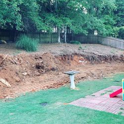 Artisan Scapes - Pushing the hill back about 8ft back to set a retaining wall.