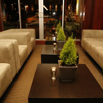 Proof Bar & Patio - a living room with couches and a coffee table - Lounges Near Me - Toronto, Ontario Proof Bar & Patio - a living room with couches and a coffee table - Lounges Near Me - Toronto, Ontario