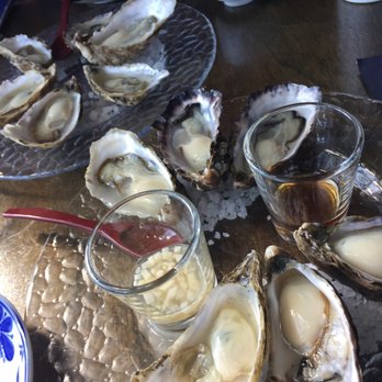 Hannyatou - Gorgeous hama hamas, a dozen to split with mignonette in shot glass on left, ponzu on right. - Japanese Near Me - Seattle, Washington