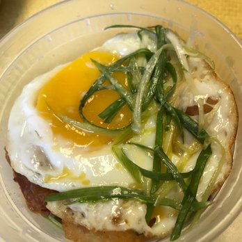 Kitchen Story - Tater Poutine (takeout). Curry tater tots,bacon, cotija, w/ fried egg and slivered green onions. - Breakfast & Brunch Near Me - Oakland, California