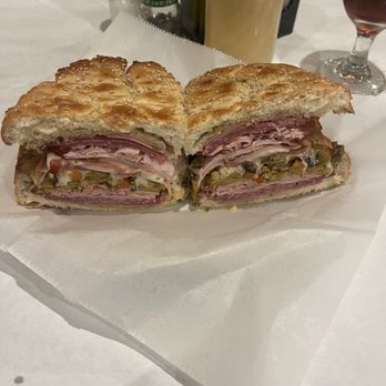 Bosco's Italian Cafe - This is just half of a muffuletta from Bosco's - Italian Near Me - Mandeville, Louisiana Bosco's Italian Cafe - This is just half of a muffuletta from Bosco's - Italian Near Me - Mandeville, Louisiana