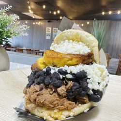 Top Arepa Venezuelan Food - Pabellon Arepa: grilled or fried, butter, shredded beef, black beans, sweet plantain and fresh white cheese.