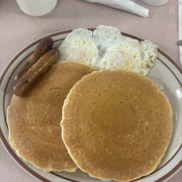 Pancakes, two fried eggs and sausage links