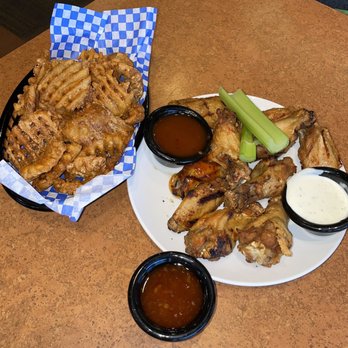 Moran's Grill - 10 piece wings, charred with a side of mango habanero sauce and sweet chili sauce. A basket of waffle fries. - American Near Me - Bellevue, Nebraska Moran's Grill - 10 piece wings, charred with a side of mango habanero sauce and sweet chili sauce. A basket of waffle fries. - American Near Me - Bellevue, Nebraska