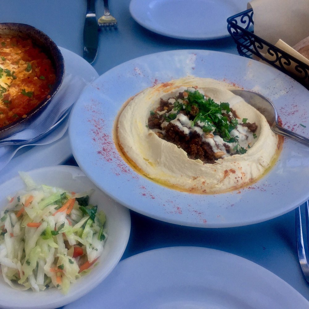 Oren's Hummus - Full spread shared by two people: hummus beef, traditional shashuka with eggs and pita. They threw in some cabbage salad side. - Mediterranean Near Me - Mountain View, California