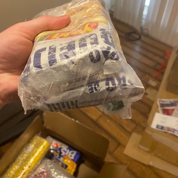 Remembr Store - a hand holding a bag of chips - Brazilian Near Me - Sunrise, Florida