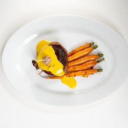 Romano Cuisine - Filet mignon with a béarnaise sauce plated with elegance .