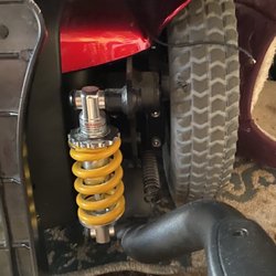 Mobility Plus of CA - Left side of electric wheelchair you can see yellow spring more loose then right side of yellow spring