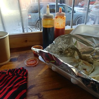 Tiny Cafe - a hot dog and a napkin on a table - Dumplings Near Me - Toronto, Ontario Tiny Cafe - a hot dog and a napkin on a table - Dumplings Near Me - Toronto, Ontario