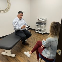 SOS 4 PAIN - Dr. Anthony Salmon doing his thorough patient intake to fully understand how he can help you heal.
