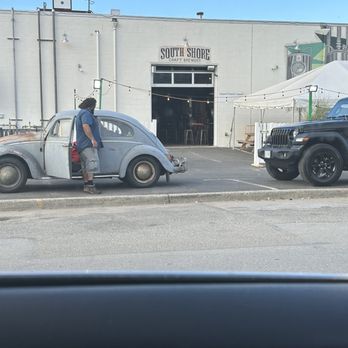 South Shore Craft Brewery - The front entrance and a local musician unloading his gear out of an old VW. - Breweries Near Me - Oceanside, New York